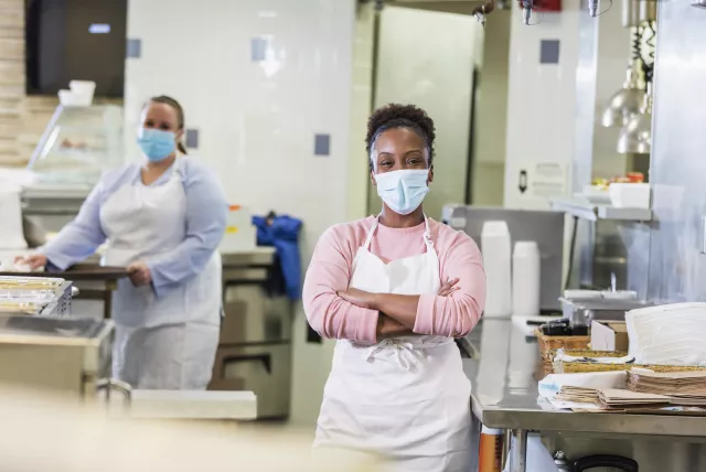 photo of two female food service workers in a cafeteria