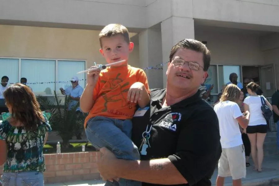 An ESP holds up his son